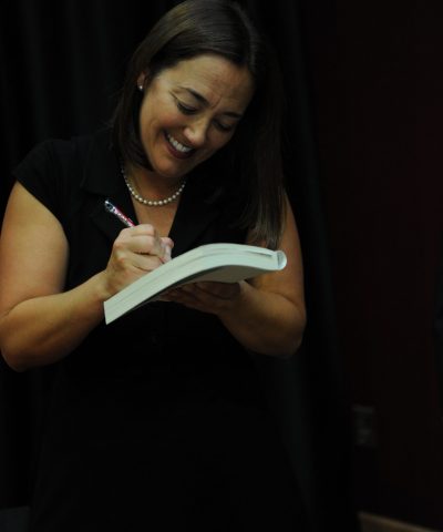 A photo of Erin Gruwell signing a book.